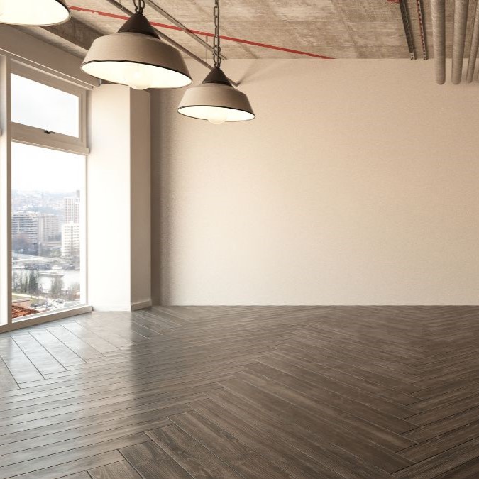 Dark herringbone wooden plank design in a room.